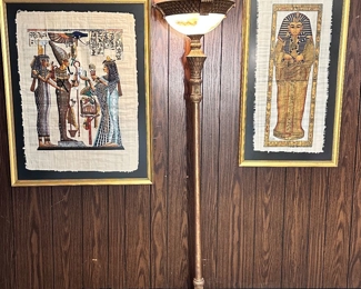 Egyptian art on papyrus and large ornate torchiere lamp.