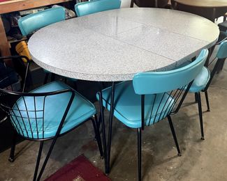 Laminate grey top with newly recoverd chairs in aqua vinyl. Middle folds and stores under table