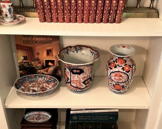 Red and gold books (Brass firedogs make great bookends.); more décor
