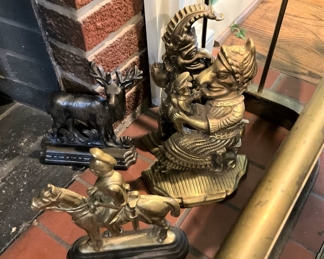 Various brass andirons, door-stoppers, and bookends including "Punch and Judy"
