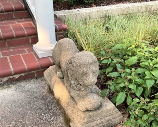 One of two concrete crouching lion garden statue  