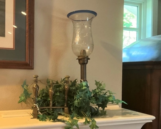 One of two brass and glass candle holders