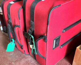 2 pieces of red luggage