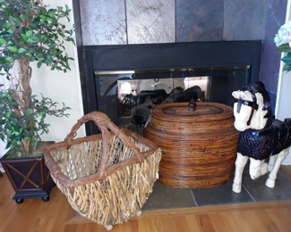 Faux plants, baskets, and wood horse.