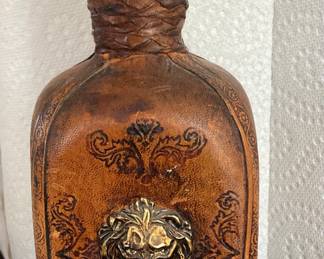 Leather bottle with lion’s head