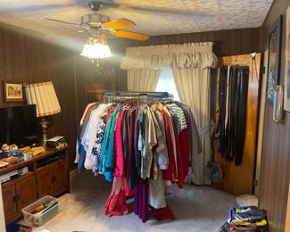 Bed room #1 with a bunch of vintage men’s and women’s clothes. 