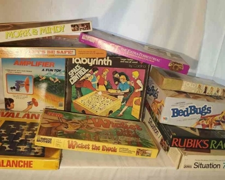 (11) Board Games In Box
Wicket the Ewok, Mork & Mindy, E.T., Avalanche, Let's Be Safe, Labyrinth, Super Amplifier, BedBugs (appears to be missing the top of bed board), Rubik's Race, Flip and Fold Fashion, and Situation 7. Also Milton Bradleys Simon game. 