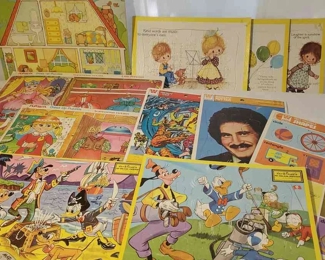 (11) Puzzles
Two Walt Disney Inlaid Puzzles. Whitman: Fantastic Four and Welcome Back Kotter Frame-Tray Puzzles. Three Susanna The Drawing Board Puzzles: 'Kind words are music to everyone's ears.' 'Laughter is sunshine of the spirit.' 'Those who bring sunshine to the lives of others cannot keep it from themselves.' Two Playskool Dress Up Puzzles: Little Princess, Summer/Winter Fashions. Six piece room puzzle. Sixteen piece 'Help Yourself Shapes' Whitman puzzle (missing the diamond). Some slight damage on some boards as seen in photos. 
