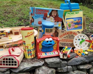 Toys And Games Lot
Various musical toys inckuding fisher price, cookie monster, and mini stage echo organ. Cooking center still in box. Clock-a-game still in box. Hot Wheels foldable service center. Ringa-majigs still in tube. Building bricks still in tube. Pound Puppies newborn with carrying case. Weights clown and match shape clock face.