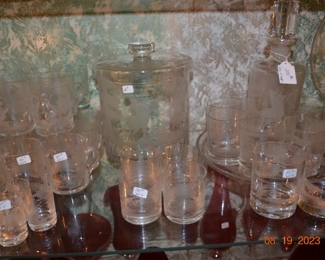 Pictures do not do this vintage bar set justice. They have what looks to be an etched scene on them with stags, birds and trees. there is an ice bucket, tray, platter, decanter, bowls and numerous sets of glasses. This is an absolutely gorgeous set of bar wear.  You need to see it in person. 