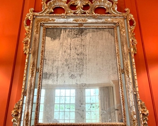 $2400; 37" x 62"; timeless gilt-painted, carved-wood mirror that alludes elegance with its antique-silvered mirror and curved top