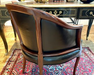 SOLD: 25" x 25" 32"; vintage black leather barrel chair with tufted seat cushion and air vents (view of back)