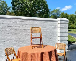 $200/each - Folding hostess tables with custom wood topper that turns it into a 60 inch round  and custom table pads (3 available) - 48 inch round; $100/each - 90 inch round custom made table linens (3 available); Additional table linens available at the sale!! $120 each (10 available); 19" x 24" x 35";  vintage rattan folding chair with custom seat cushions;  2 additional available with the slat rattan back
