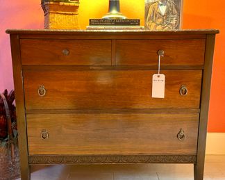 $300; 40" x 21" x 36"; four-drawer chest of drawers with carving around the edge of the top