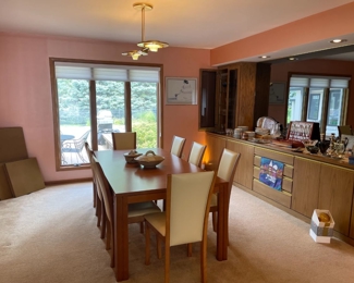 Skovby Danish teak dining room table and matching Skovby danish chairs. Table sits 8 comfortably, in addition there are two hidden leaves. Set also comes with the custom pads