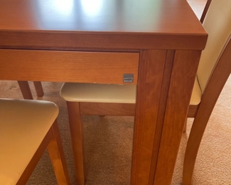 Skovby Danish teak dining room table and matching Skovby danish chairs. Table sits 8 comfortably, in addition there are two hidden leaves. Set also comes with the custom pads