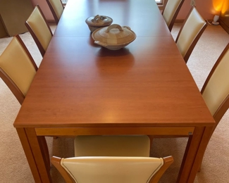 Skovby Danish teak dining room table and matching Skovby danish chairs. Table sits 8 comfortably, in addition there are two hidden leaves. Set also comes with the custom pads