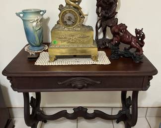 The blue Roseville vase and gold clock are sold.