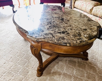 $150
OUTLOOK INTERNATIONAL, LTD OVAL SOLID WOOD COFFEE TABLE WITH STONE VENEER 
52”L x 34”W x 18.5”H