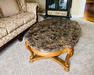 $150
OUTLOOK INTERNATIONAL, LTD OVAL SOLID WOOD COFFEE TABLE WITH STONE VENEER 
52”L x 34”W x 18.5”H