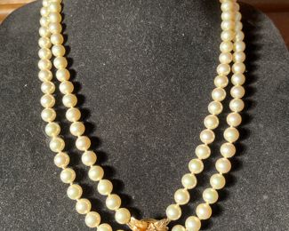 Den:  This is a closer photo of the necklace that is displayed in the cabinet.  It's a double strand of faux pearls with a14K gold flower clasp which has a center diamond surrounded by rubies.