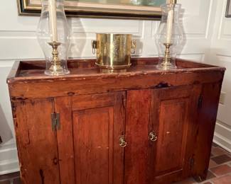 Dining Room:   An original signed piece by Missouri artist M. Charles Rhinehart (a closer photo follows) hangs above an antique dry sink. Also shown are a pair of candlesticks/hurricanes and a brass planter.