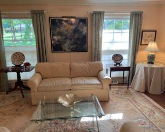 Living Room:  A KRAVET 75" neutral color sofa with duck down has detached back and seat cushions.  Its coordinating 63" sofa is nearby.  The tilt-top table and one-drawer table flanking the sofa and its decor are also for sale.  Closer photos follow.