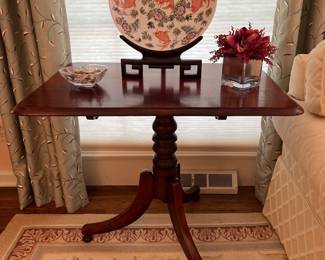 Living Room:  An antique tilt-top table displays a porcelain plate on stand and other decor.