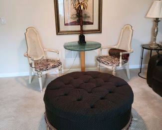 Tufted Round Ottoman, Modern Round Crackled Glass Side Table, Pair of Cane Back Chairs w/ Zebra Print Upholstered Seats, and Large Framed Palm Art Print