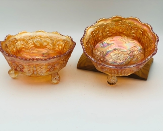 Pair of marigold carnival glass bowls with ball and claw feet