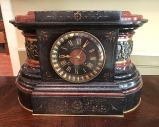 Marble mantle clock. 
Bronze with inlay rouse and black marble
