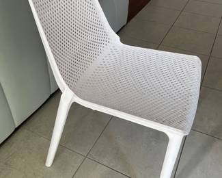 $250; Set of 8 outdoor plastic modern chairs (not being sold individually). Rain falls through easily and they are comfortable.