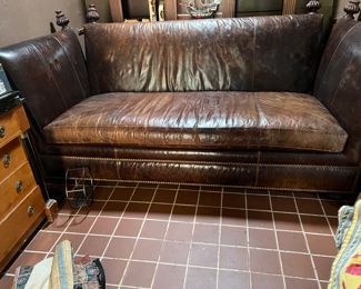 Most likely made by Baker....very large brown leather coach..
