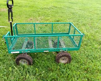 Green metal garden utility cart.  Towable with folding sides.  
