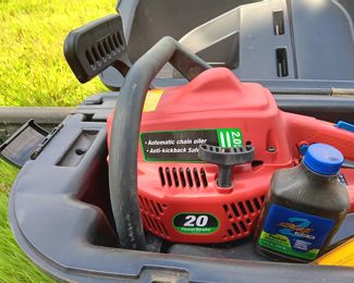 Homelite chain saw in case with chain and oil. 20 Power stroke engine.