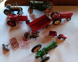 Assortment of vintage metal tractors -- International, John Deere, Harvester
