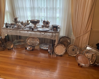 Dozens of silver serving pieces including an ornate punch bowl and a set of Gorham sterling flatware