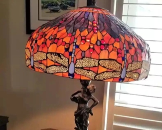 Tiffany style lamp with bronze lady holding a jug with a circular marble base and bronze stand below. Stands approx. 33" (h) and the lampshade is approx. 23" across. The price has been slashed on this beauty!