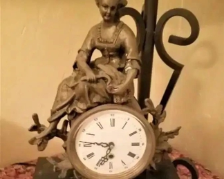Antique french clock with a bronze sitting atop the clock. Has a hand-painted illustration with a very special key to turn this 24 hour clock.