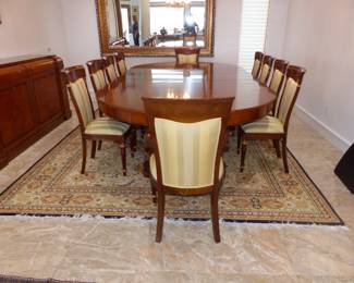 Large dining table with 10 chairs, sideboard, area rug