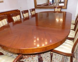 Large dining table with 10 chairs, sideboard, area rug