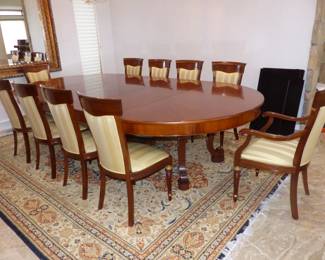 Large dining table with 10 chairs, sideboard, area rug