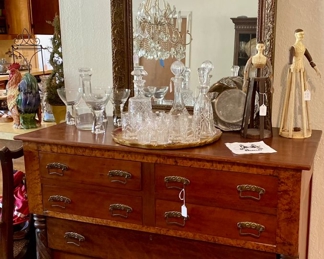 Antique buffet used as a bar with large framed mirror and Chrystal decanters