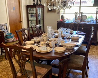 Ethan Allen dining table with Lennox Christmas dishes and Chrystal. Glass Chandier with curio in the corner