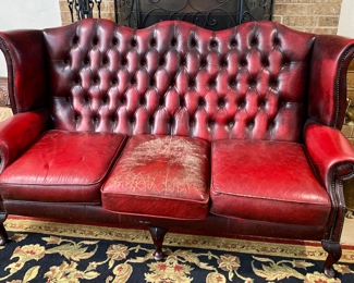 Red Leather couch and wool rug