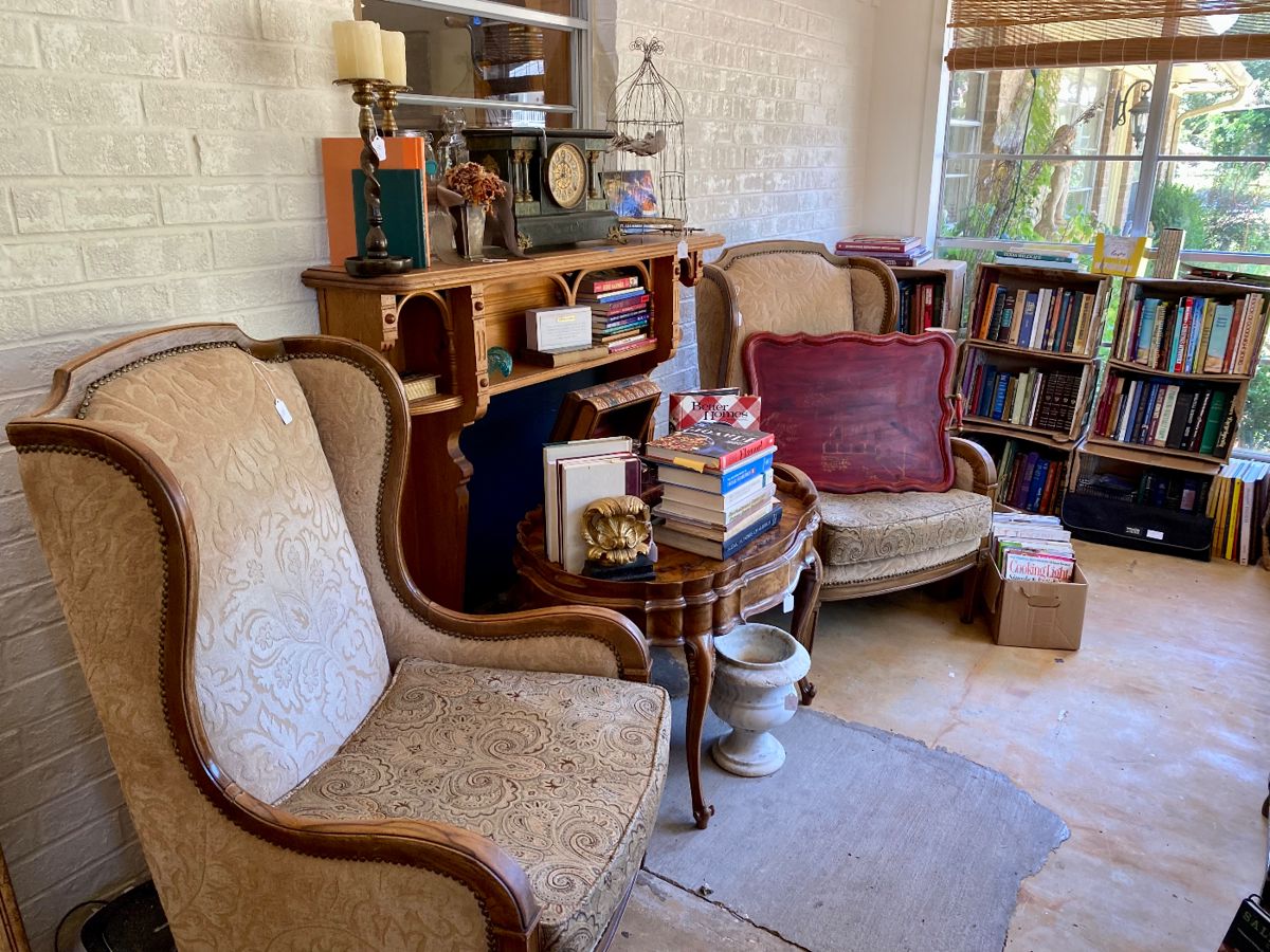 Wing back chairs, burl tray/coffee table, books and magazines.