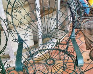 Vintage French Wrought Iron Peacock Chairs. There is a pair.