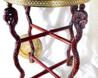 JAMA919 Ornately Carved Folding End Table Base Brass Trays: Intricately carved legs fold flat or open to hold a tray or table top. 2 brass trays included. &nbsp;Note large tray does not fit securely on top of table legs.
