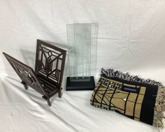 JIFI120 Frank Lloyd Wright Assortment: An assortment of Frank Lloyd Wright art pieces, including a Robbie House&nbsp;window&nbsp;pane statue and blanket, as well as&nbsp;a Frank Lloyd Wright Lake Geneva hotel design iron magazine rack.&nbsp;
