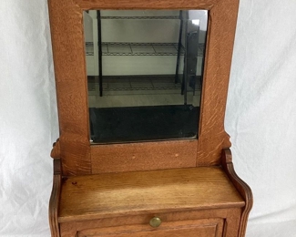 JIFI126 Antique Hanging Mirrored Cabinet: This is an antique hanging mirrored cabinet. This piece could have been used for shaving and/or other vanity uses, such as applying makeup. The cabinet is relatively heavily due to it's solid wood build.&nbsp;
